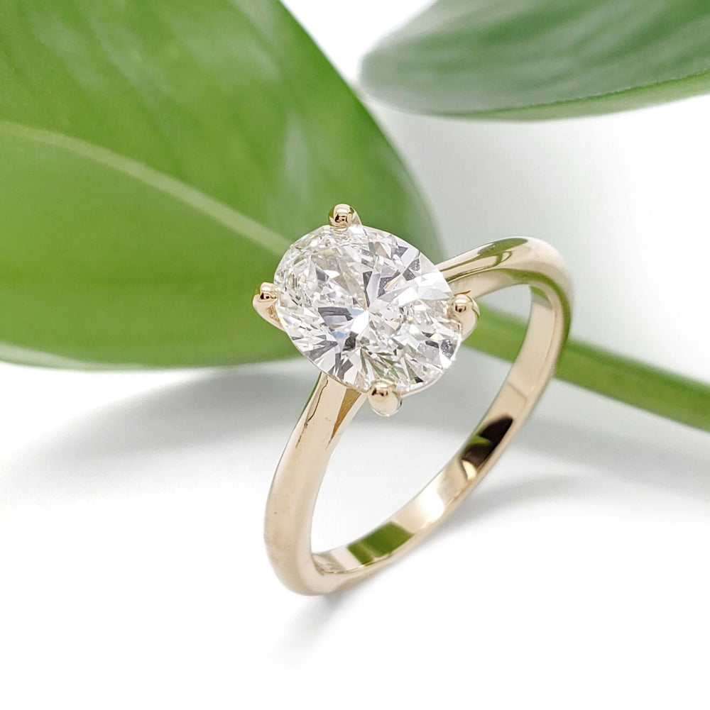 Oval lab diamond engagement ring in 14kt yellow gold with leaf background
