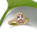 Oval peach sapphire and diamond halo engagement ring in 14kt yellow gold, floral engraved band, leaf background