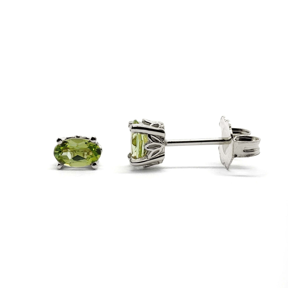 Oval green peridot stud earrings in 14kt white gold with floral basket setting