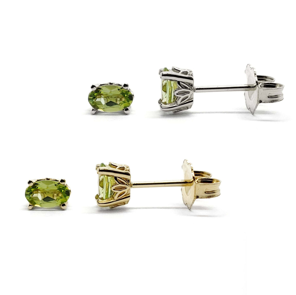 Pair of oval cut green peridot stud earrings in 14kt yellow and white gold with floral basket setting