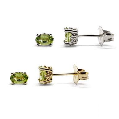 Pair of oval cut green peridot stud earrings in 14kt yellow and white gold with floral basket setting