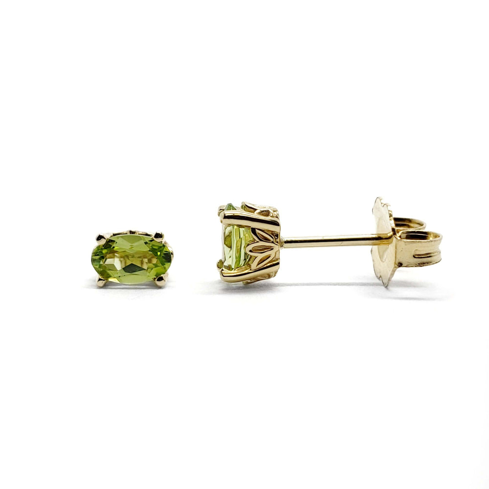 Oval green peridot stud earrings in 14kt yellow gold with floral basket setting