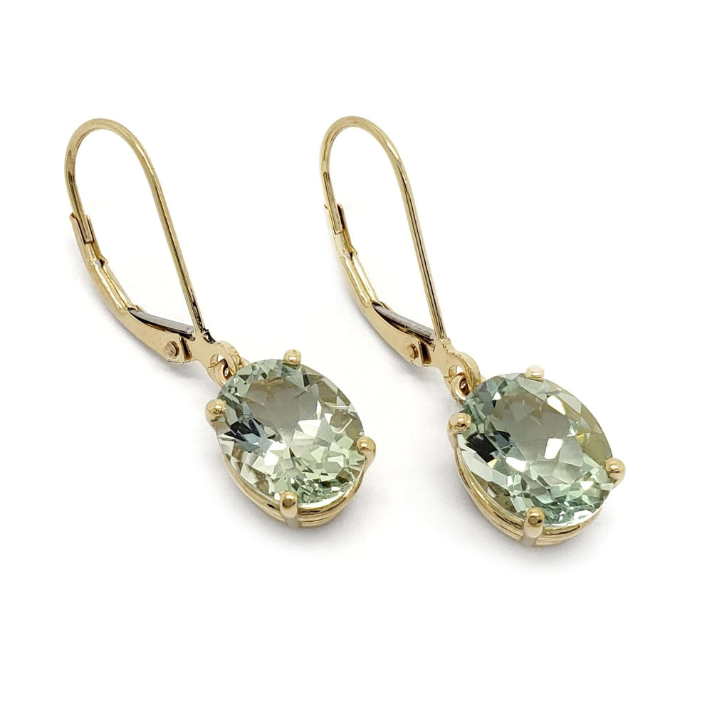 Pair of oval prasiolite dangle earrings in 14kt yellow gold on white background