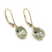 Pair of oval prasiolite dangle earrings in 14kt yellow gold on white background