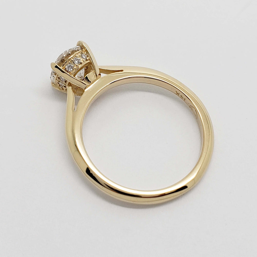 Overhead view of 14kt yellow gold engagement ring with lab grown diamond and hidden halo