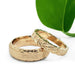 Pair of 14kt yellow gold wedding rings, one with leaf engraving and one with brushed finish