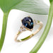 Pear-shaped blue Australian sapphire and diamond ring in yellow gold, with leaf background