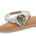 Pear rose cut green sapphire engagement ring in 14kt white gold on wood background