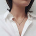 Pear rose cut green sapphire pendant in 14k yellow gold on black chain worn on neck