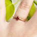 Pear ruby and yellow gold engraved ring worn on hand