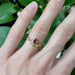 Pear ruby engraved ring stacked with gold leaf and diamond band on hand