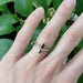 Pear ruby ring stacked with marquise gemstone and diamond bands on hand