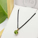 Peridot and 14kt yellow gold filigree pendant displayed in Era Design box