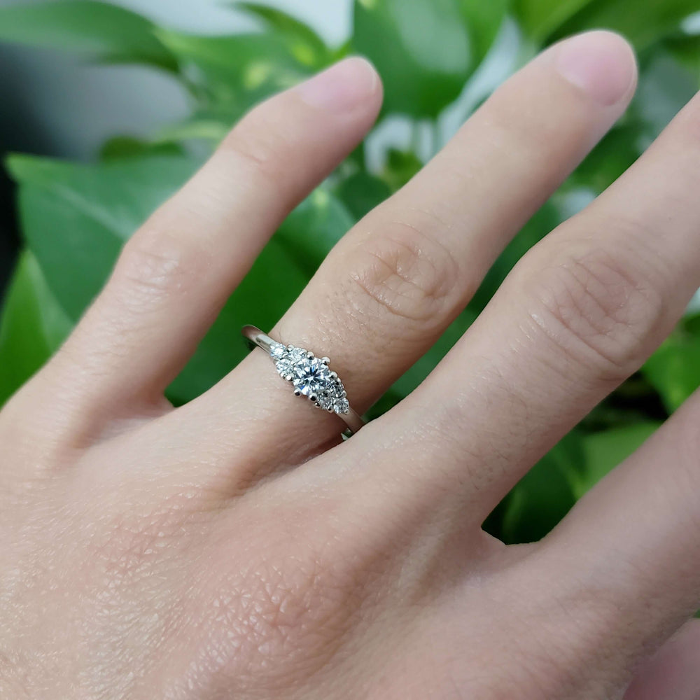 Petite Zira 14kt white gold lab diamond engagement ring worn on hand