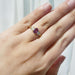 Pink sapphire and lab diamond yellow gold ring shown on hand