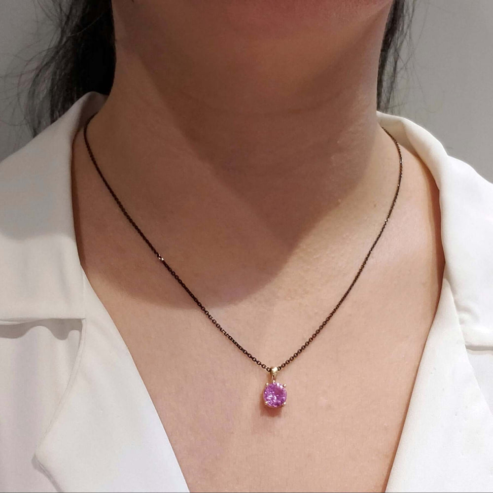 Pink spinel and yellow gold pendant necklace worn on model