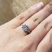 Platinum lab diamond engagement ring worn on hand, showing intricate band details