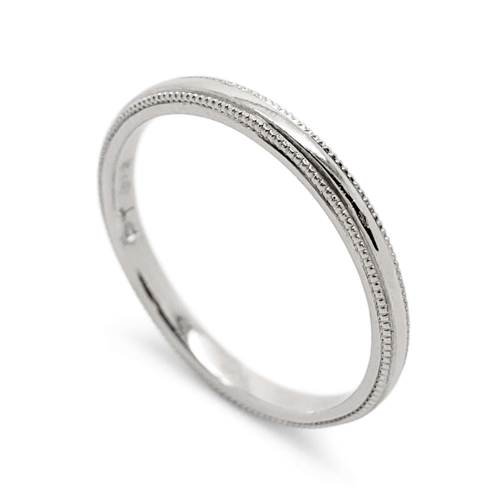 Handcrafted platinum wedding band with millgrain detailing by Era Design