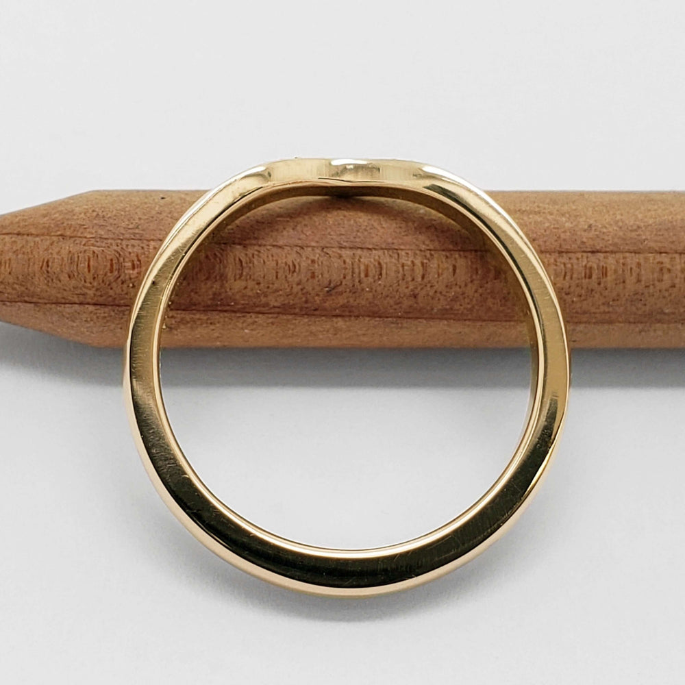 Polished 14k yellow gold band, side view, showing curved chevron shape