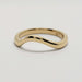 Polished 14kt yellow gold chevron wedding band on white background