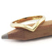 Polished 14kt yellow gold chevron wedding ring displayed on a pencil