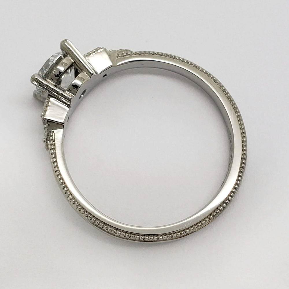 Profile view of 14kt white gold engagement ring with milgrain detail and lab diamond setting
