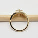 Profile view of 14kt yellow gold ring with shield cut sapphire and filigree, on a pencil