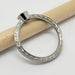 Profile view of engraved 14k white gold ring with bezel setting, no stone visible