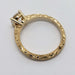 Profile of engraved 14kt yellow gold band with round lab diamond in solitaire setting