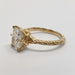 Profile of engraved 14kt yellow gold engagement ring with cushion cut lab diamond