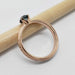 Side view of engraved rose gold ring with blue sapphire, showing millgrain detail