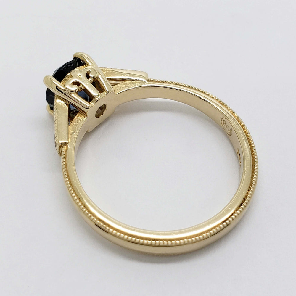 Profile of 14K yellow gold Montana sapphire ring showing millgrain band and gallery detail
