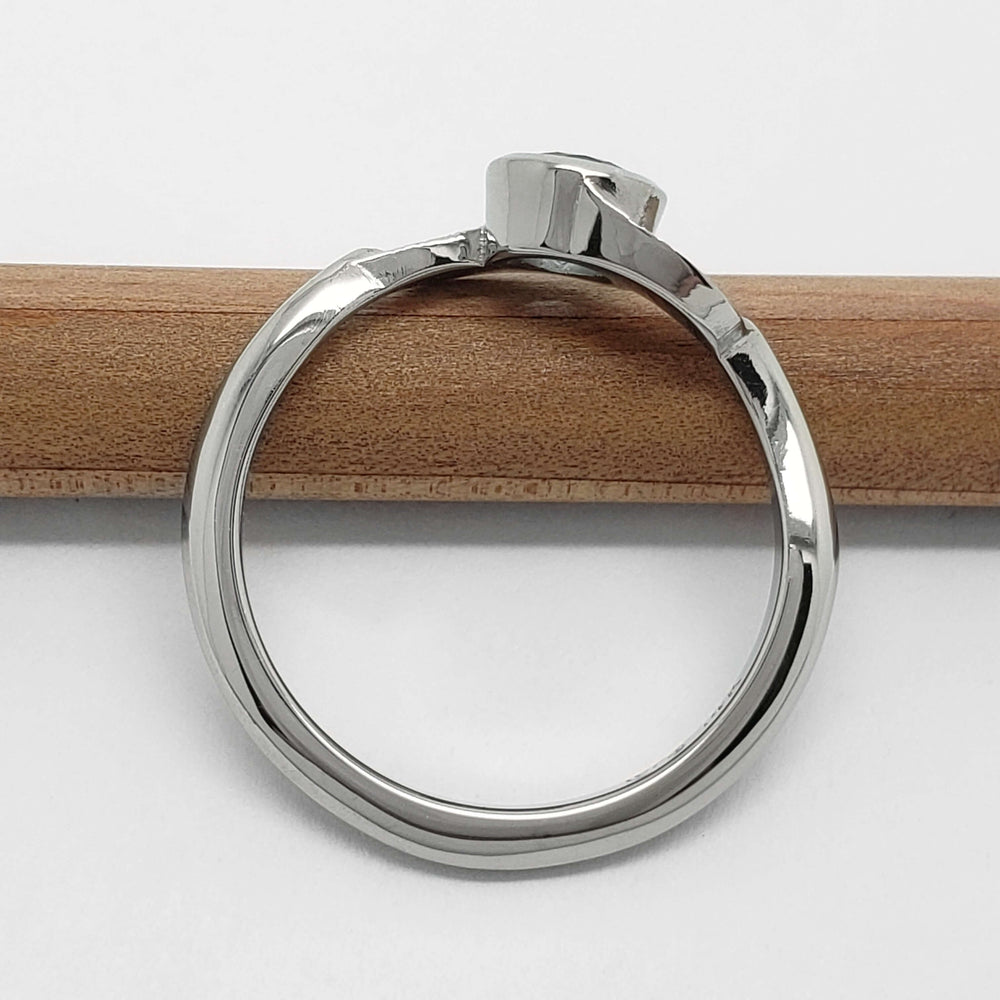 Profile view of white gold Montana sapphire ring with leaf motif