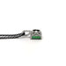 Profile view of white gold green tourmaline pendant on black chain against white background