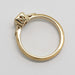 Profile of yellow gold engagement ring with millgrain and cutout details