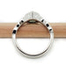 Profile view of 14kt white gold green sapphire engagement ring showing band and setting
