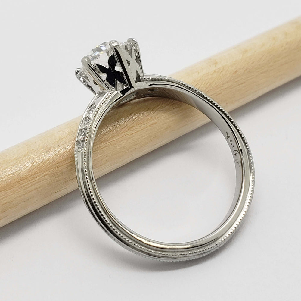 Profile of 14kt white gold engagement ring with moissanite center and diamond accents