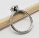 Profile of 14kt white gold engagement ring with moissanite center and diamond accents