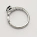 Side profile of 14kt white gold ring with millgrain detail and blue Montana sapphire