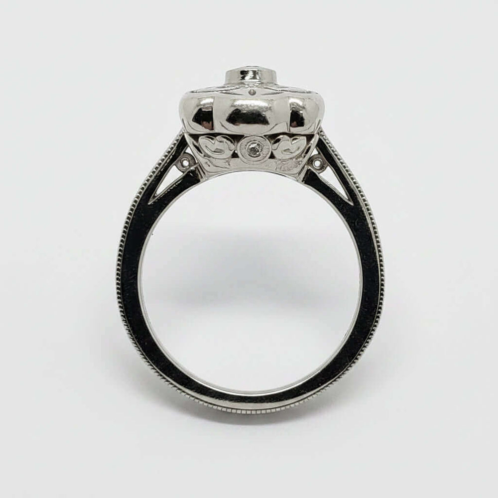 Profile view of Edwardian style white gold diamond ring with engraved details
