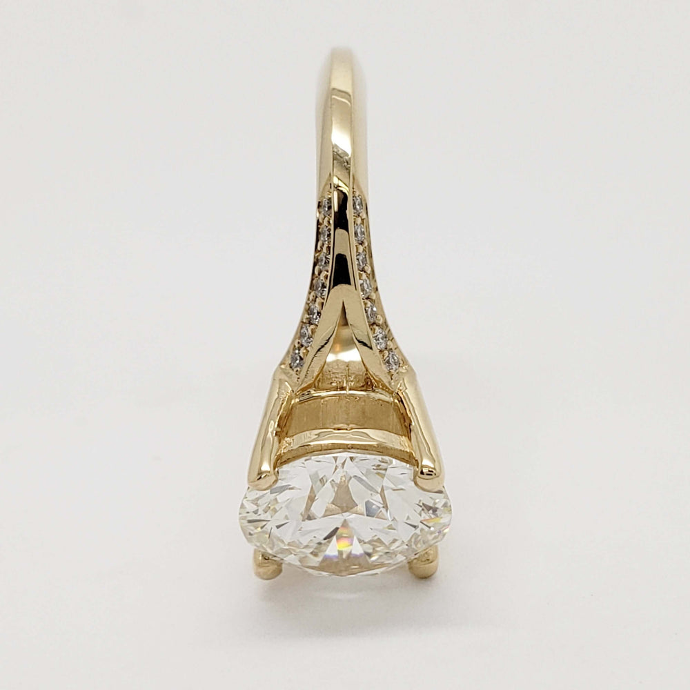 Profile view of yellow gold engagement ring with round lab diamond and pave-set accents