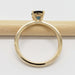 Side profile of yellow gold ring with teal Australian sapphire and diamond accents