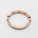 Rear view of 14k rose gold wedding ring with leaf and diamond details