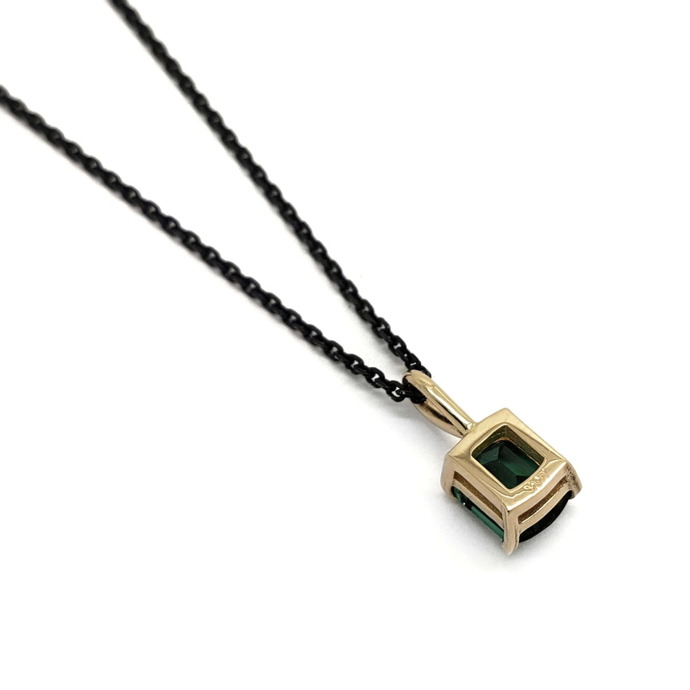 Back view of 14kt yellow gold barrel cut green tourmaline pendant on black chain