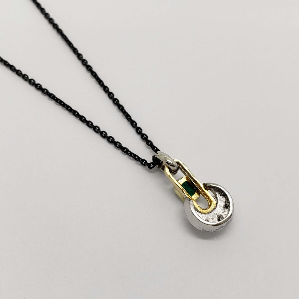 Back view of 18kt yellow and white gold pendant with emerald and diamonds on black chain