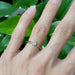 Rose cut diamond engagement ring in white gold shown on hand