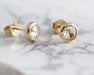 Rose cut moissanite earrings in 14kt yellow gold resting on marble