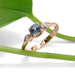 Handcrafted rose gold Montana sapphire and marquise diamond ring with leaf in background