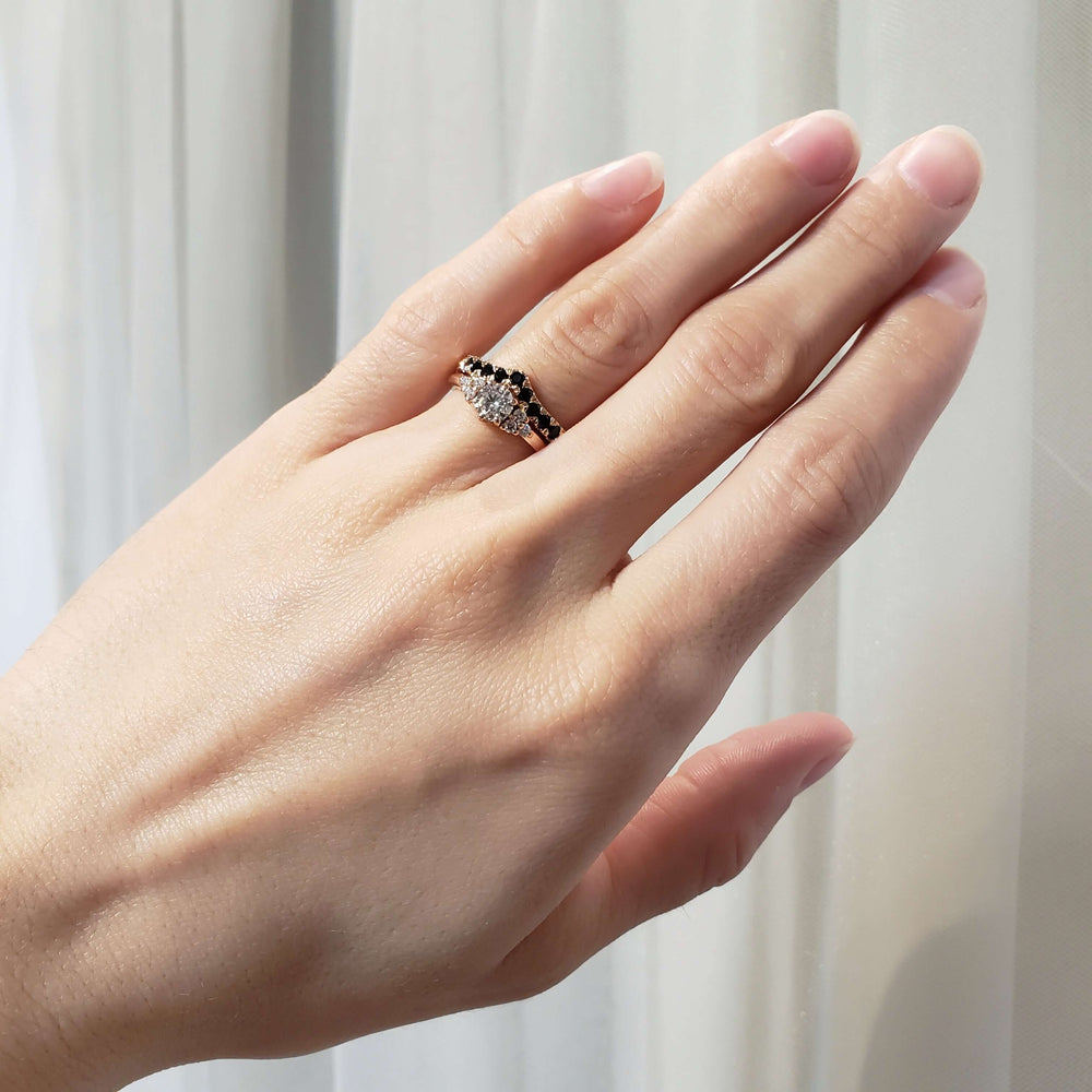 Chevron black spinel wedding ring in rose gold stacked with diamond ring on a hand