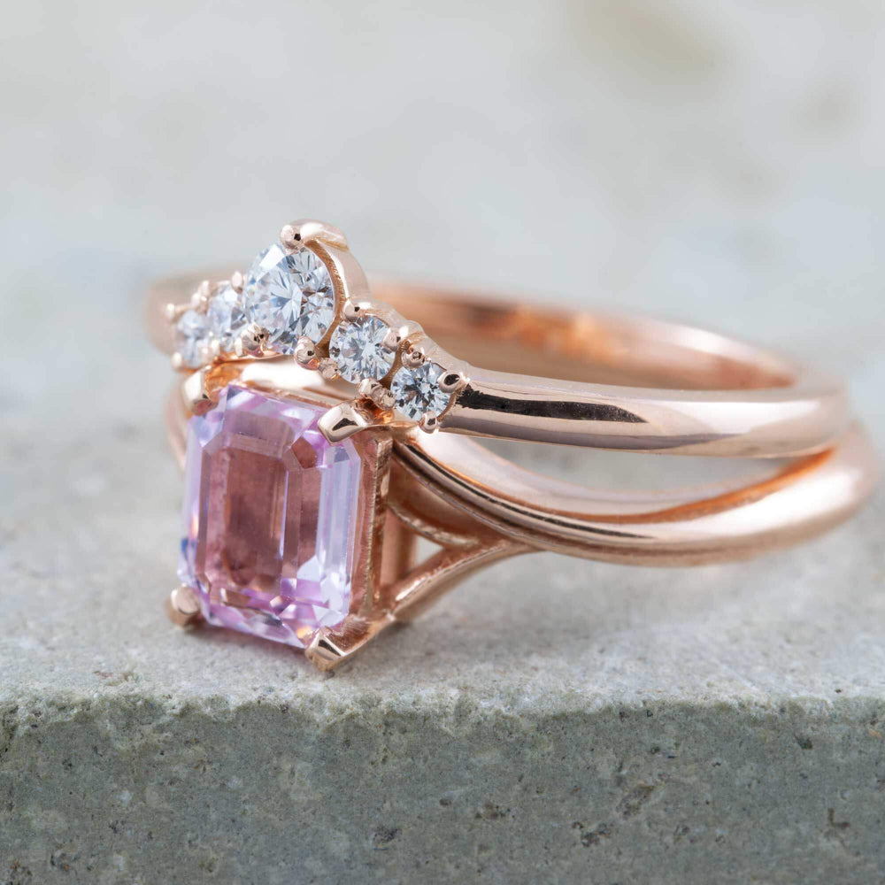 Rose gold chevron diamond wedding ring stacked with a pink emerald-cut gemstone ring